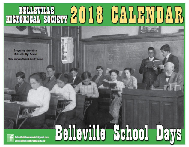 Cover of 2018 calendar showing black-and-white photo of students in a schoolhouse